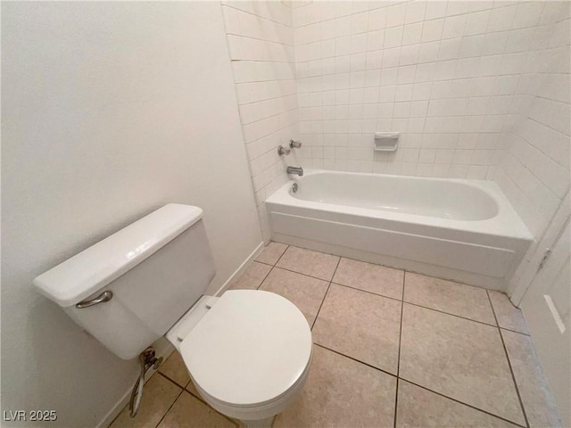 bathroom featuring toilet, tub / shower combination, and tile patterned floors