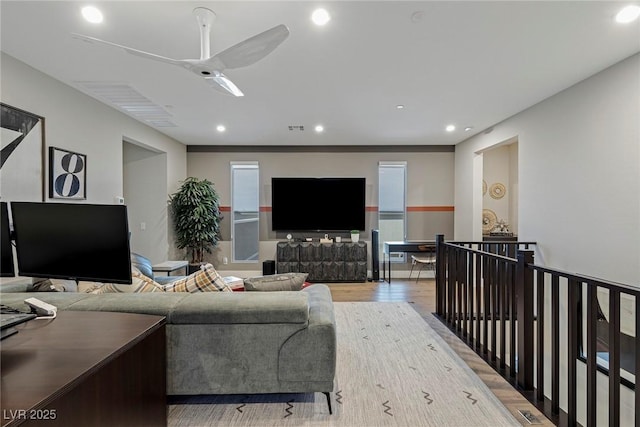 living room featuring ceiling fan and light wood-type flooring