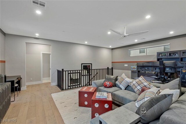 living room with ceiling fan and light wood-type flooring