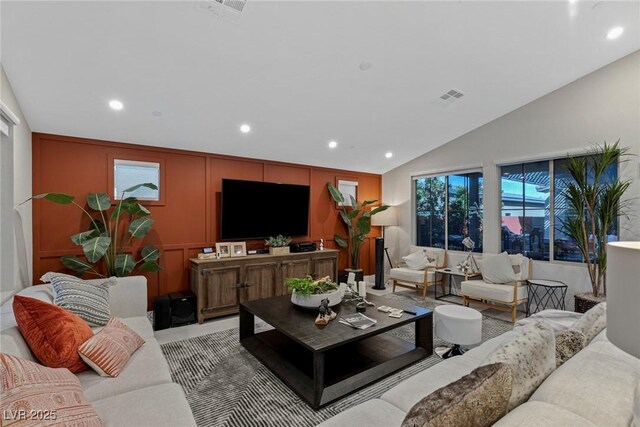 living room featuring vaulted ceiling and a wealth of natural light