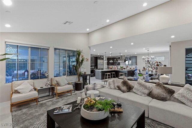 living room with an inviting chandelier and vaulted ceiling