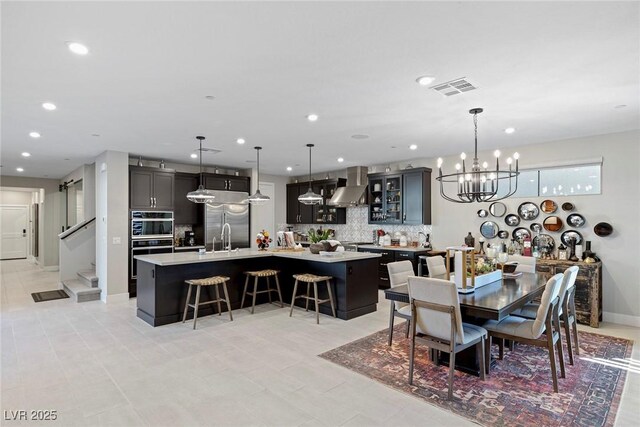 dining area with sink, a chandelier, and light tile patterned floors