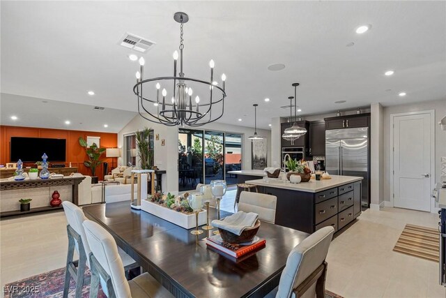 dining area featuring an inviting chandelier and vaulted ceiling