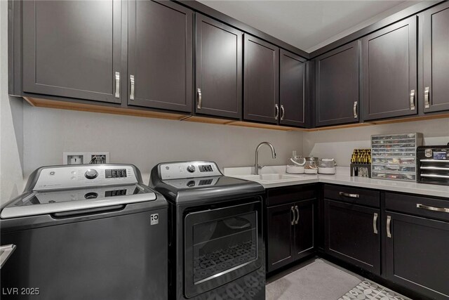 laundry area featuring sink, separate washer and dryer, and cabinets