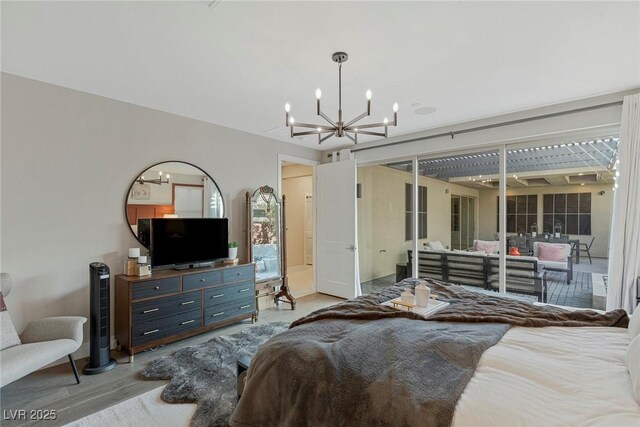 bedroom with a chandelier and access to outside