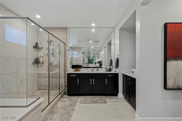 bathroom with vanity and a shower with shower door