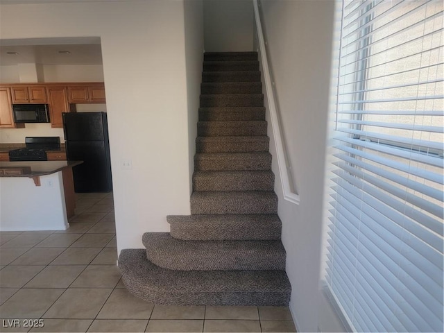 stairway with tile patterned flooring