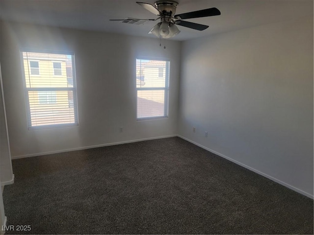 carpeted spare room with ceiling fan