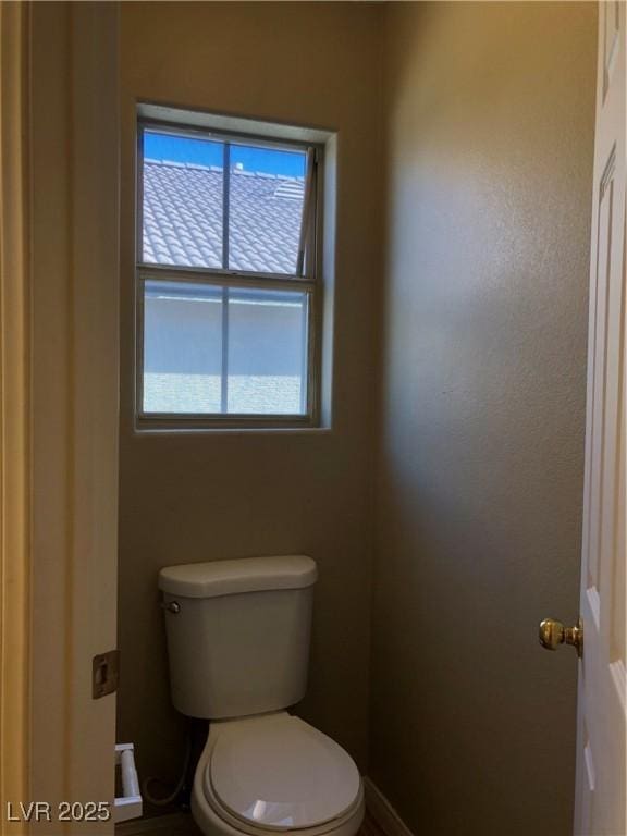 bathroom featuring toilet and a wealth of natural light