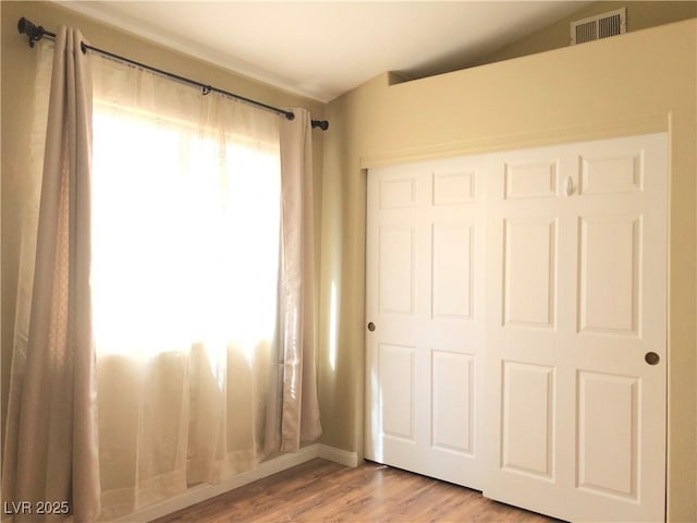 unfurnished bedroom with a closet and light hardwood / wood-style flooring