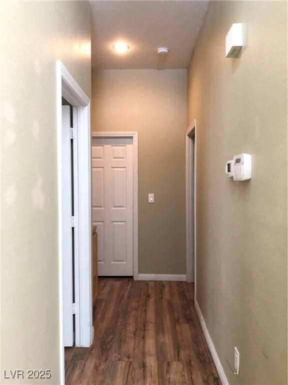 hallway with dark hardwood / wood-style floors