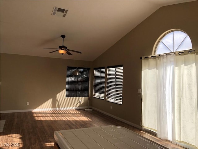 spare room with lofted ceiling, ceiling fan, and dark hardwood / wood-style floors