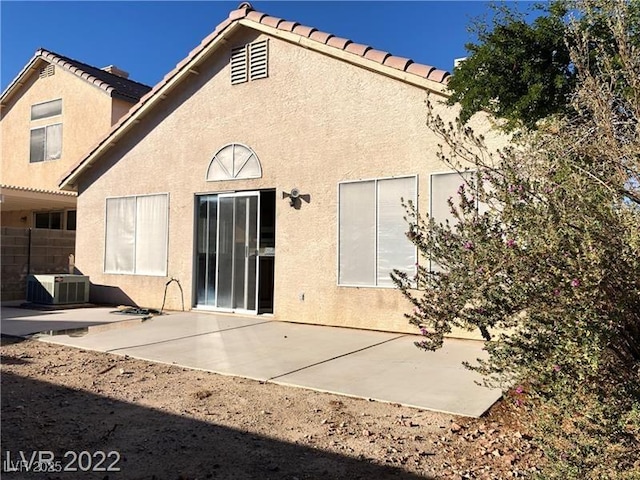 rear view of property with a patio area and cooling unit