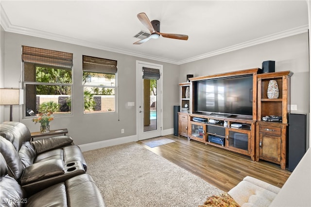 living room with light wood-type flooring, ceiling fan, and ornamental molding