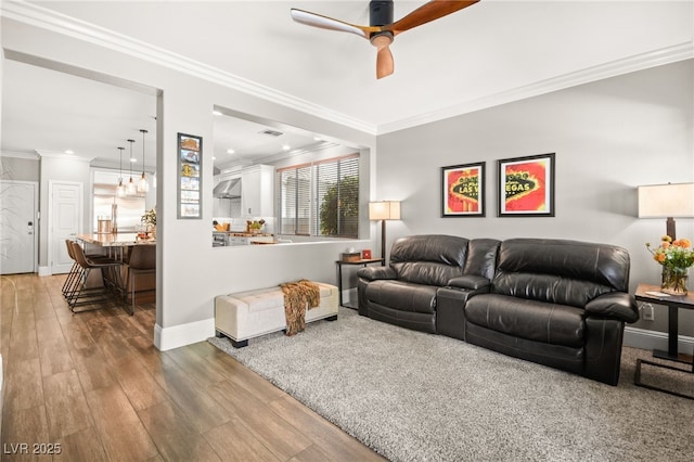 living room featuring ornamental molding, ceiling fan, and hardwood / wood-style floors