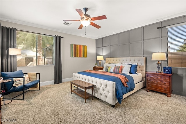 carpeted bedroom with ceiling fan and crown molding