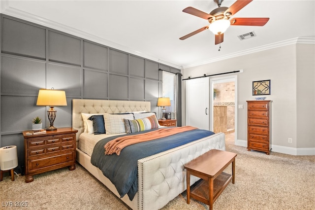 carpeted bedroom featuring ensuite bath, ceiling fan, ornamental molding, and a barn door