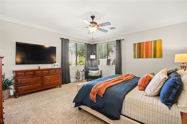 carpeted bedroom featuring ceiling fan and crown molding