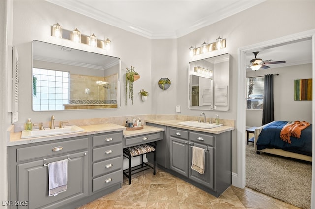 bathroom with ornamental molding, ceiling fan, walk in shower, and vanity