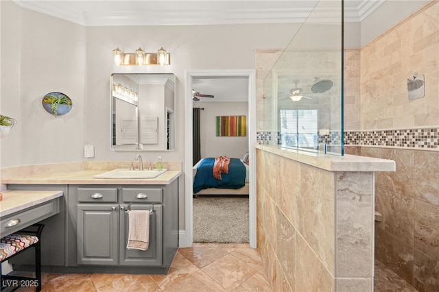 bathroom with tile walls, walk in shower, crown molding, and vanity