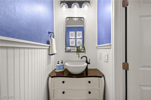 bathroom featuring ornamental molding and vanity