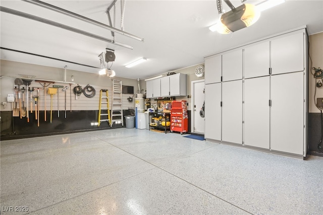 garage with a garage door opener and water heater