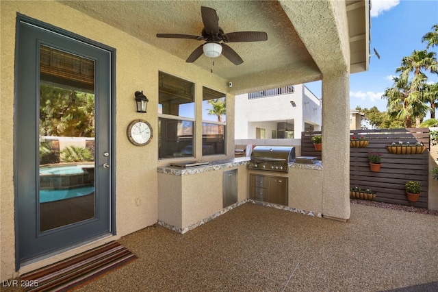 view of patio with exterior kitchen, area for grilling, and ceiling fan