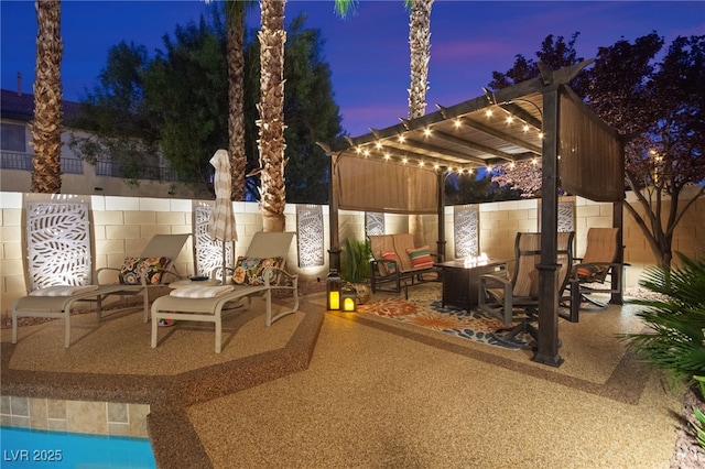 patio terrace at dusk featuring a fire pit and a pergola