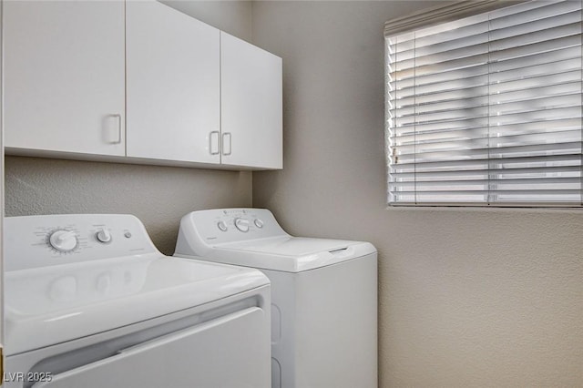 washroom with washer and clothes dryer and cabinets