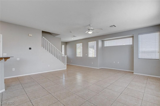 unfurnished living room with ceiling fan and light tile patterned flooring