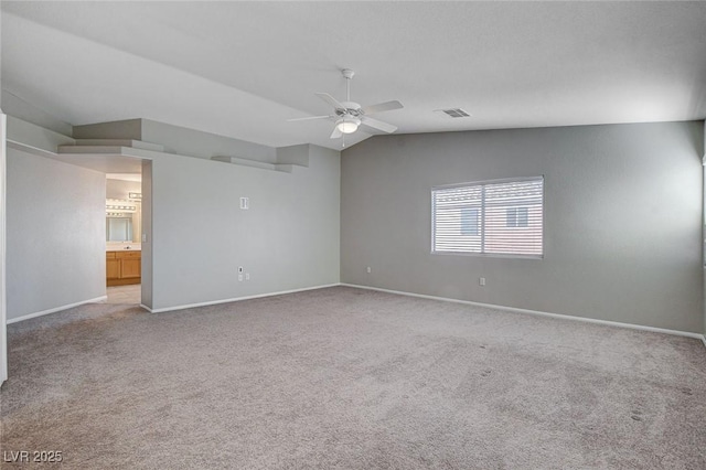 carpeted empty room featuring ceiling fan and vaulted ceiling