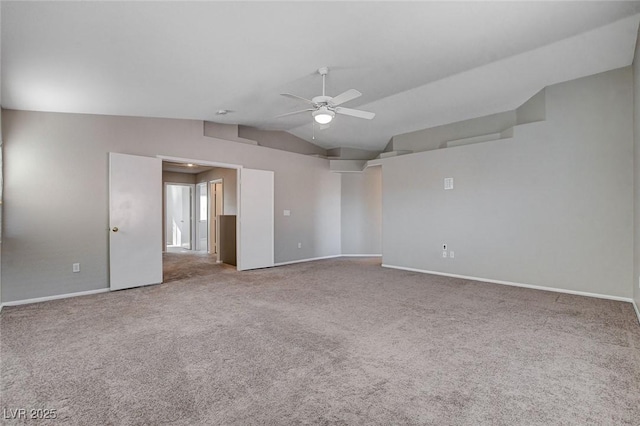 carpeted spare room with ceiling fan and lofted ceiling