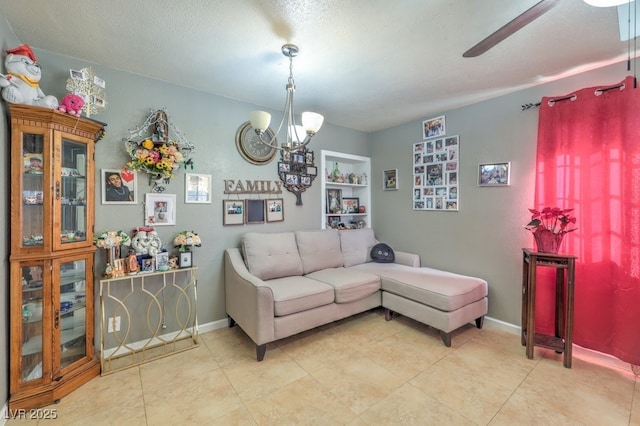 living room with ceiling fan with notable chandelier, a textured ceiling, and built in features