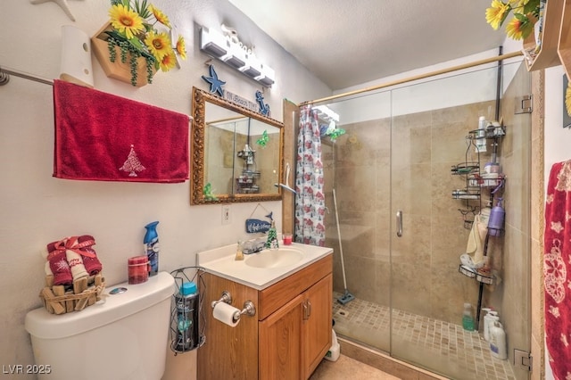 bathroom with toilet, an enclosed shower, and vanity