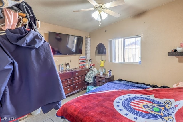 tiled bedroom featuring lofted ceiling and ceiling fan