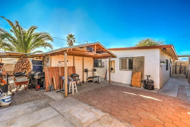 rear view of property featuring a patio area