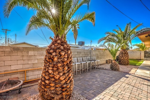 view of patio with an outdoor bar and an outdoor fire pit