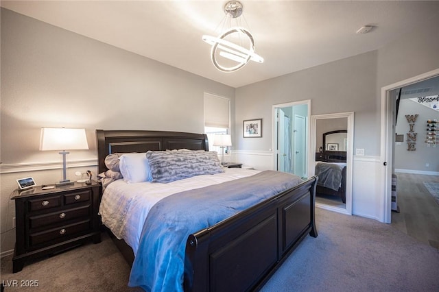 bedroom with an inviting chandelier and light colored carpet