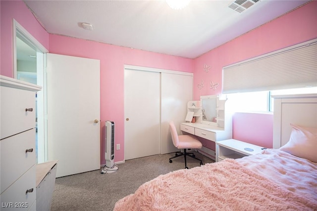 bedroom featuring a closet and light carpet