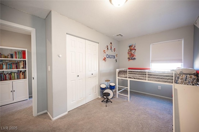 bedroom featuring light colored carpet and a closet