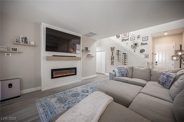 living room with a fireplace and hardwood / wood-style flooring