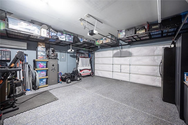 garage featuring a garage door opener, an AC wall unit, and stainless steel fridge