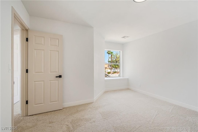 unfurnished room with light colored carpet