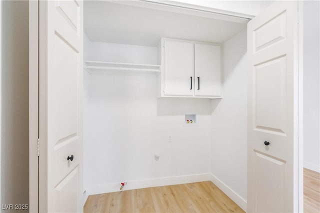 laundry area with washer hookup, cabinets, light hardwood / wood-style flooring, and gas dryer hookup