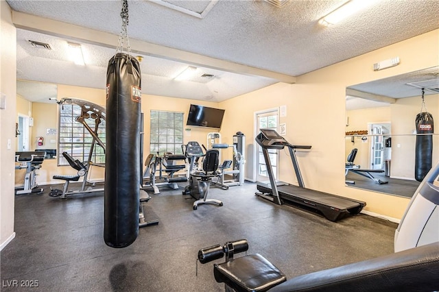 exercise room with a textured ceiling