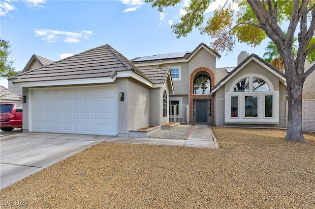 view of front of property with solar panels and a garage