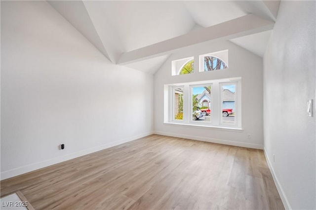 bonus room with light wood-type flooring and vaulted ceiling