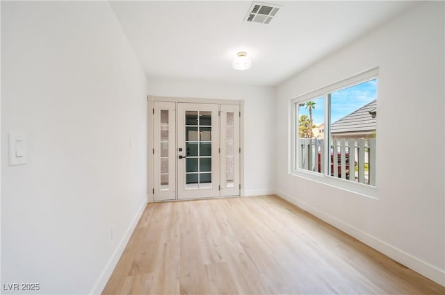 spare room with light hardwood / wood-style flooring