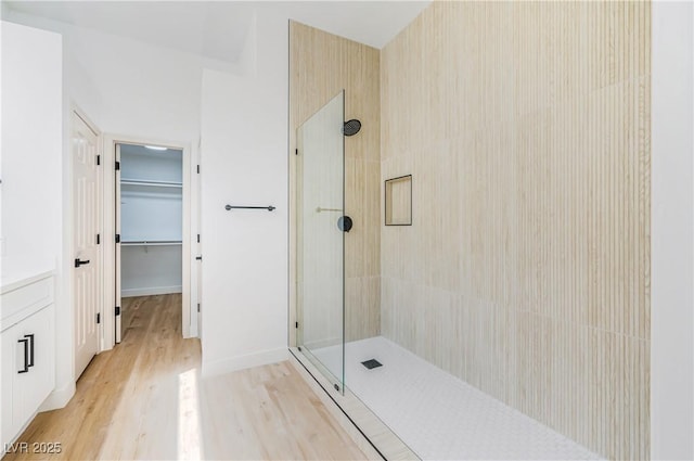 bathroom featuring wood-type flooring and walk in shower