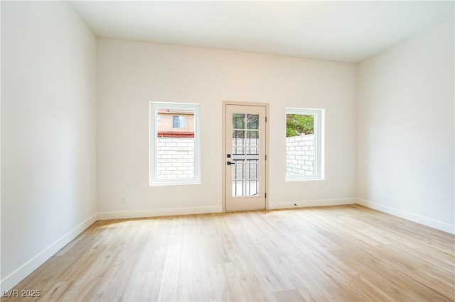 unfurnished room with light wood-type flooring